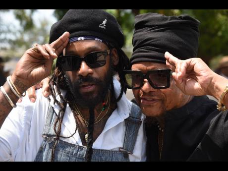 Showing their support, following their musical tribute are Tarrus Riley (left) and Maxi Priest.