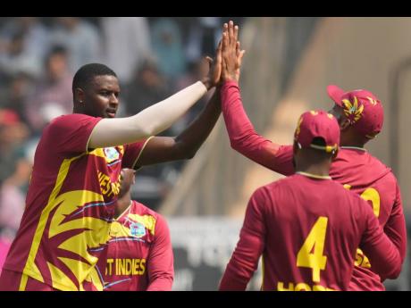 West Indies’ Jason Holder (left) celebrates the wicket of Nepal’s Aarif Sheikh during the T20 World Cup cricket match in Mumbai, India on February 15.