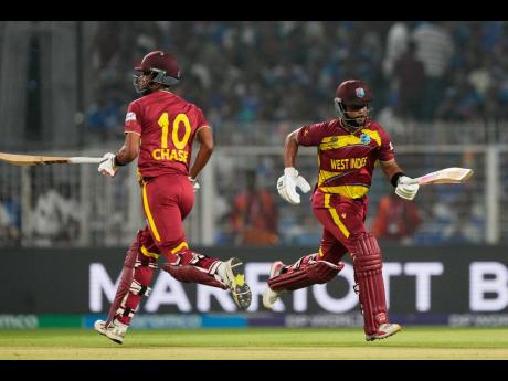 West Indies’ captain Shai Hope (right) and batting partner Roston Chase run between the wickets during the T20 World Cup cricket match against India in Kolkata, India, on March 1.