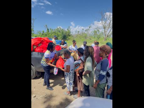 Members of the Shipping Association’s team distributing relief packages to residents in Watercress, Westmoreland.