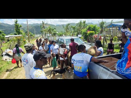 Members of the Shipping Association’s team distributing relief packages to residents in Goldsmith, Westmoreland.