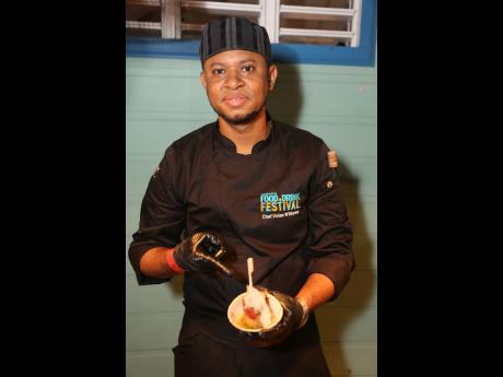 Chef Volae Williams displays his smoked pimento pork belly, paired with rice and peas arancini, callaloo pesto and a jerk tamarind ginger sauce.