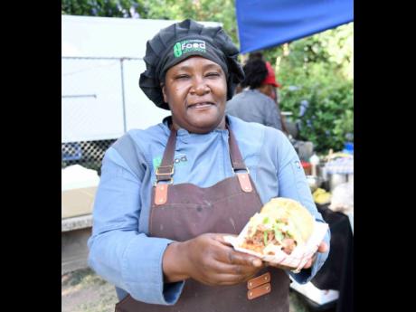Chef Simone Walker-Barrett of Street Food Saturdays shows off her pulled pork doughnut sandwich.