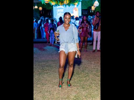 Left: Photographer Monique Thomas switches perspectives at Jamaica Food and Drink Festival’s Decade 2.0, posing for a shot in distressed denim, a front-tie shirt and Bridget Rose sandals. 