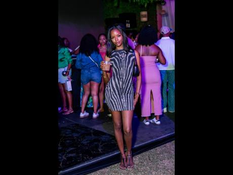 Miqueal-Symone Williams, Miss Universe Jamaica 2020, shows her off-duty model style in a shirt dress, shoulder bag and Bridget Kay Sandals. 