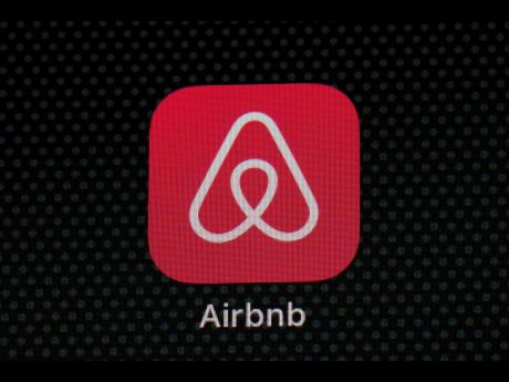 The Airbnb app icon is displayed on an iPad screen.