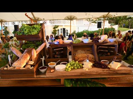 The main spread, an elevated charcuterie display featuring a variety of cheeses, crackers, fruits and breads, prepared by Chef Oji Jaja.