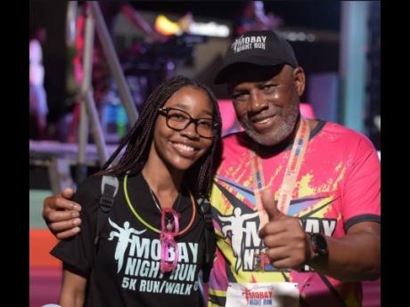 Jade Cohall-Cunningham shares a moment with Howard Ward, chairman of the Howard Ward Benefit Foundation, at the 2024 MoBay Night Run.