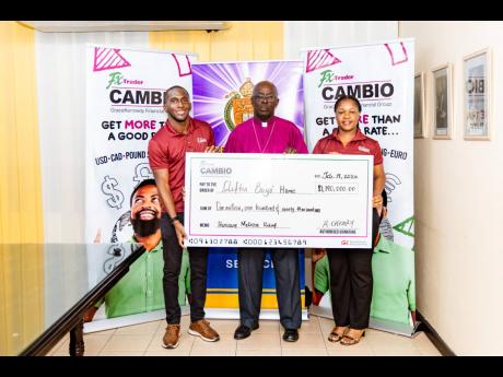 Romario Creary (left), head of FX Trader Cambio and Calecia Robinson, FX Trader’s marketing manager, flank Bishop Leon Golding of the Diocese of Jamaica and the Cayman Islands, operators of the Clifton Boys’ Home.