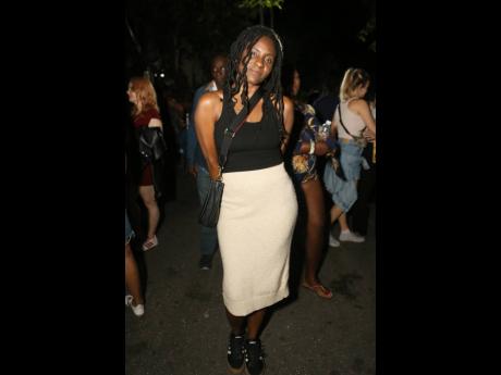 Reggae singer Jah9 keeps it casual and comfortable offstage in a black tank and black-and-white low tops.  