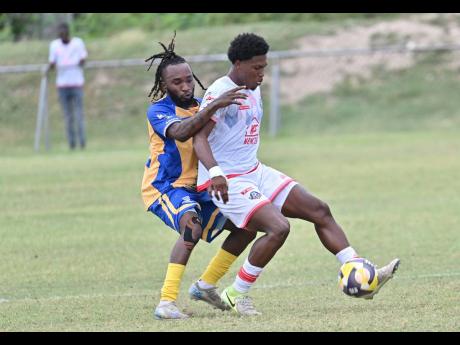 Orel Miller of Portmore United shields the ball from Harbour View’s Kenly Deacon during yesterday’s Jamaica Premier League match at the Ferdi Neita Park. Portmore won 4-2. 