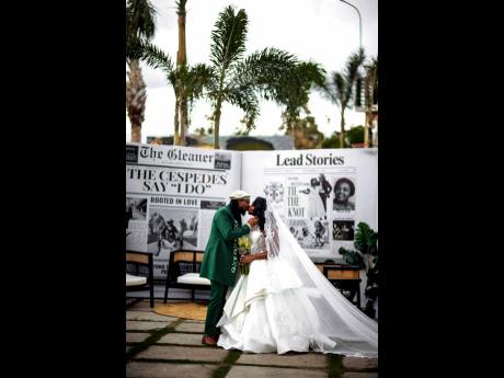 The couple share an enchanting kiss in front of an extravagant newspaper announcement marking their wedding.