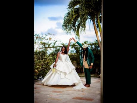 Giving his bride a twirl, Kelsey-Jo stole the show in a layered fit-and-flare dress with a vintage-inspired bodice. She designed the look herself, working with a Nigerian tailor and graphic artist to bring it to life.