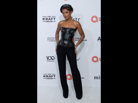 Credit: AP Keke Palmer brings vintage glam to the Elton John’s viewing party, in this a sculpted 2001 YSL by Tom Ford corset top.
