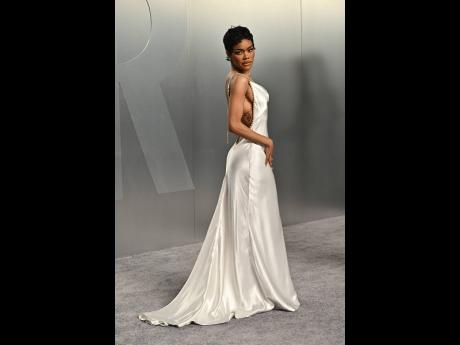 Credit: AP Teyana Taylor was a vision in white, arriving in a backless Chanel gown with chain-strap detailing.