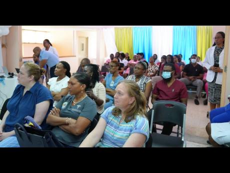 Credit: Contributed Doctors, nurses and medical students listen during the “Coordinated Care in Penetrative Cardiac Trauma” seminar at May Pen Hospital where the historic cardiac trauma case was presented on Thursday.
