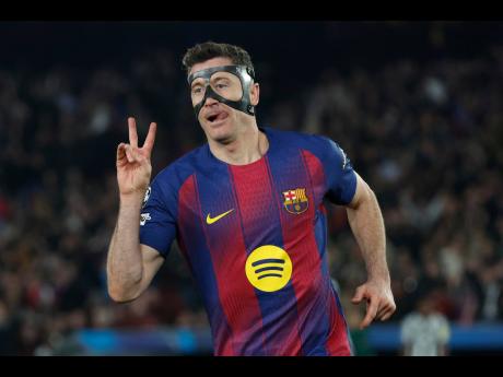 Barcelona's Robert Lewandowski celebrates after scoring his side's sixth goal during the Champions League round of 16, second leg football match between FC Barcelona and Newcastle United FC in Barcelona, Spain on March 18, 2026. (AP Photo/Joan Monfort)

