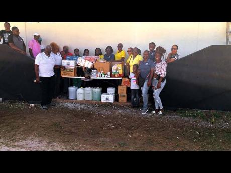 Members of the JN Circle Ocho Rios, Port Maria and Gayle chapters, along with the JN Circle Falmouth Chapter, pause for a group photo after presenting donations to Noah’s Ark Children’s Home and the Falmouth Infirmary in Falmouth. The contributions inc