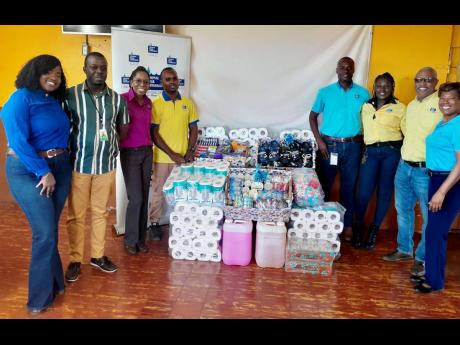 NWC representatives share a moment with Manning’s Boys Home after donating essential items to the institution. In photo from left are;  Shanique Brown, team leader - distribution and maintenance (Control Center); Richard Aiken, manager, Manning’s Boys 