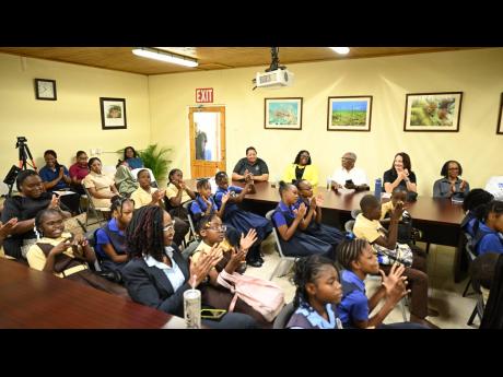 Students and teachers of Waltham Abbey Primary and Infant School and Discovery Bay Primary and Infant School in St Ann, along with other stakeholders, participate in activities inside the newly furnished conference room at the University of the West Indies
