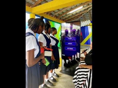 Students from St Thomas Technical High School engage with newly launched NEPA educational games during the National School Environmental Club Programme Workshop, guided by Senior Public Education and Community Outreach Officer, Ava Tomlinson.
