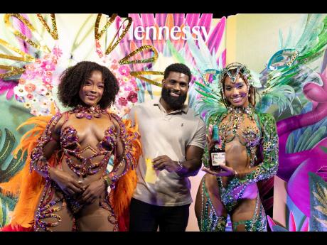 Credit: Contributed Content creator and model Andre Estafan is flanked by Yard Mas models Amina McKenzie (left) in Ebony and Chante-Marie Samlal in Picasso.