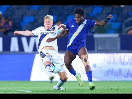 Mount Pleasant’s Alex Marshall (right) staves off the challenge of an LA Galaxy player during the first leg of their Concacaf Champions Cup round-of-16 game in Los Angeles last week.