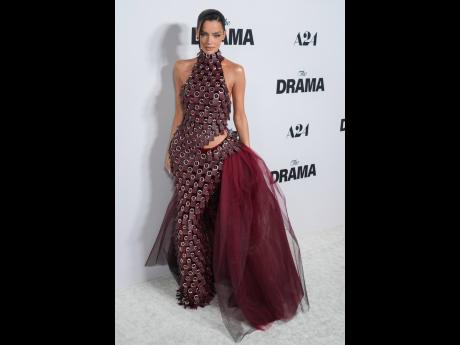 Maura Higgins wears a mahogany red halter Do Long embellished gown. 