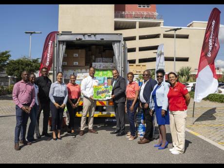GraceKennedy presents essential hygiene and household products donated by Procter & Gamble to the Ministry of Health and Wellness on March 6 at the GraceKennedy Headquarters in downtown Kingston.