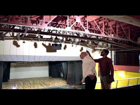 Jeffrey Hall , vice-chairman and CEO of Pan Jamaica Group (left) and Sanjay Phillips, engineering and capital projects manager at Pan Jamaica Property Company discuss the technical logistics of upgrading the Little Theatre's central air conditioning system