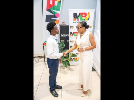 Sharon Heslop-Holt, manager of commercial business development and marketing at MBJ Airports Limited, greets Damario Hutchinson, one of the tertiary beneficiaries of the MBJ Foundation Charity Run/Walk Grant.