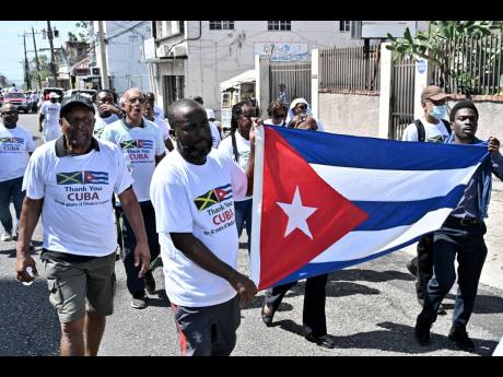 Supporters of Cuban medical professionals participate in the ‘Gratitude Walk’ to show gratitude and appreciation to the Cuban people for their 50 years of medical support to the Jamaican people. The group walked from Hanover Street to Heroes Circle in 