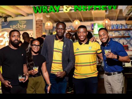 Credit: Contributed Miguel Coley (second right), Reggae Boyz assistant coach, poses with members of the J. Wray & Nephew Ltd team (from left) Campari Brand Manager Jerome Walters; Brand Activator Shanice Mitchell; Event Execution Specialist Tesfaye Brown; Marketing Manager Pa