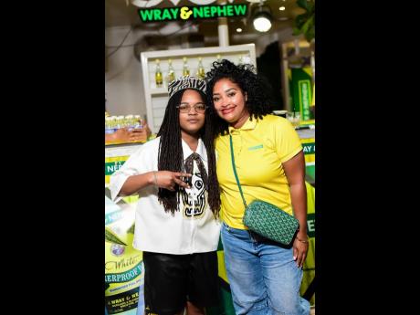 Credit: Contributed Reggae star Koffee (left) and Kerry Ann Bryan, Wray Rum brand manager, pause their confab for a quick photo.