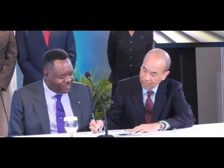 President of the Jamaica Employers’ Federation (JEF), Wayne Chen (right), and Caribbean Examinations Council (CXC) Registrar and CEO, Dr Wayne Wesley, sign the Partnership Engagement Agreement (PEA) during the 2026 CXC Ministerial Forum opening ceremony,