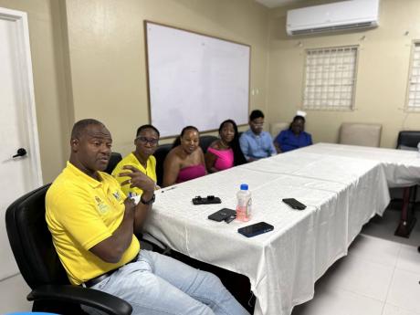 Credit: Photo by Mickalia Kington Chief Executive Officer Roan Grant engages with stakeholders and members of the Support Your Girlfriends Foundation in a discussion during the donation ceremony at Savanna-la-Mar Public General Hospital.