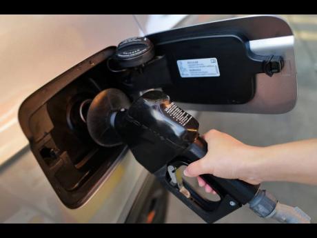 Credit: (AP Photo/Nam Y. Huh) A person fills up her vehicle's gas tank at a gas station in Buffalo Grove, Ill., Thursday, March 19, 2026.