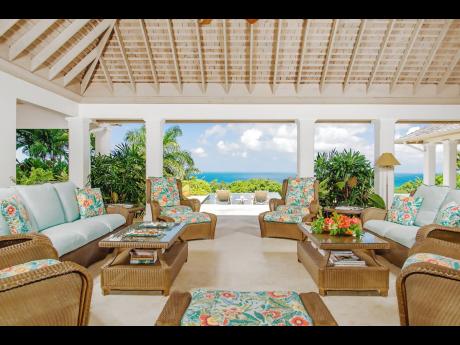 Credit: Nigel Lord Relax in the outdoor living room overlooking lush greens and the sea.