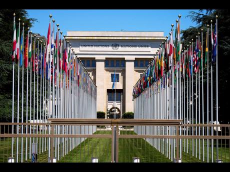 Credit: AP FILE - Flagpoles line in rows in front of a building of the United Nations in Geneva, Switzerland, June 14, 2021.