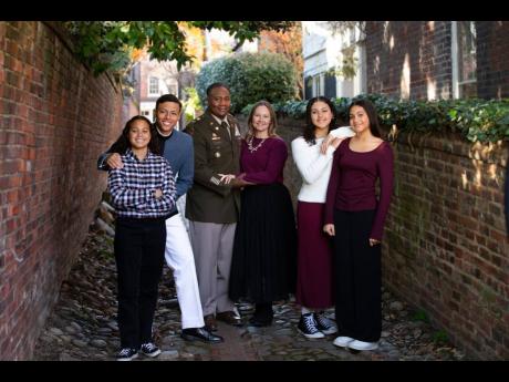 Credit: Contributed Col. Mark Denton (second left) and wife Teresa (third right) flanked by their children (from left) Haley, Zachary, Markey and Makayla.