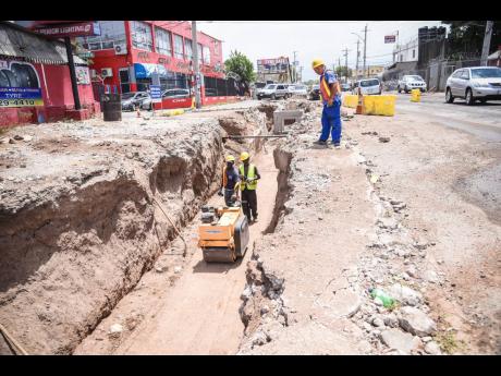 Credit: Workmen operate a road roller along a section of roadway under the Hagley Park Road Improvement Project in St Andrew in 2018.
