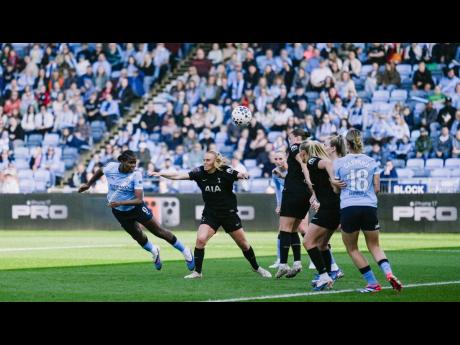 Credit: Courtesy of mancity.com Courtesy of mancity.com
Manchester City and Jamaica striker Khadija Shaw (left) plants a powerful header on her way to scoring one of three goals in a Women’s Super League game against Tottenham Hotspur at the Joie Stadium in Manchester, England yesterd
