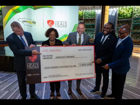 Minister of Culture, Gender, Entertainment and Sport Olivia Grange (second left) is joined by David Hoenemeyer, chief operating officer of Seminole Gaming (left), and Jamaica’s Consul General to Miami Oliver Mair (third right), for a ceremonial cheque ha