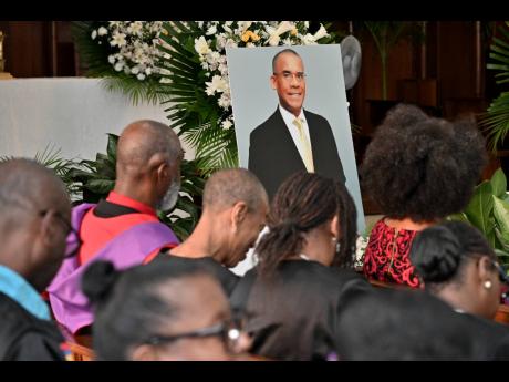 Mourners at the funeral for Dr Tomlin Paul, the late deputy principal of The University of the West Indies, Mona, held yesterday at the University Chapel in St Andrew. 