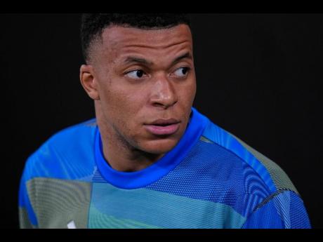 Real Madrid's Kylian Mbappe looks on before the Spanish La Liga soccer match between Real Madrid and Atletico Madrid in Madrid, Spain, Sunday, March 22, 2026. 