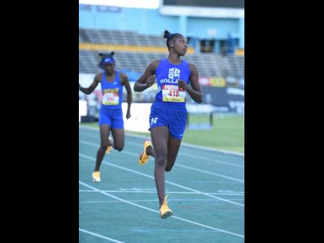 Holland High’s Shanoya Douglas runs 11.85 seconds to win her heat and advance to the Girls’ Class One 100m semifinals at the ISSA/GraceKennedy Boys and Girls’ Athletics Championships on March 24, 2026. (Ian Allen photo)