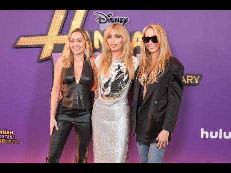 From left: Brandi Cyrus, Miley Cyrus, and Tish Cyrus-Purcell arrive at the premiere of the ‘Hannah Montana 20th Anniversary Special’.
