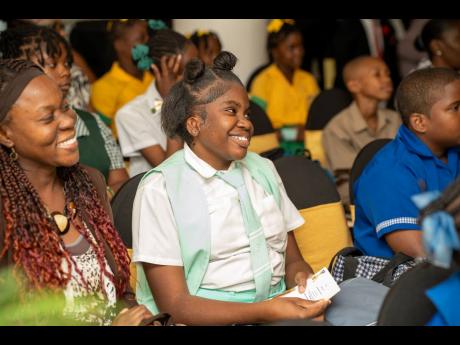 Student of the Lister Mair Gilby School for the Deaf, Dayanna Jackson, enjoys the recognition ceremony held on March 19 in Kingston for students who participated in the Sustainable Development Goals (SDG) Youth Creative Expression Competition organised by 