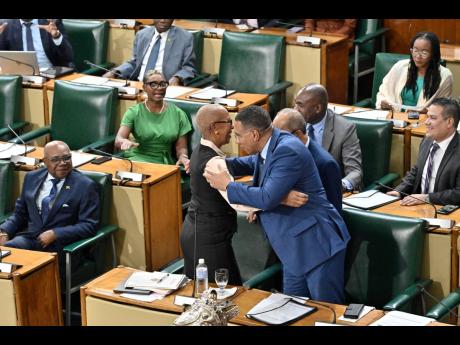 Prime Minister Dr Andrew Holness embraces Fayval Williams, minister of finance and the public service, after her closing of the 2026-2027 Budget Debate in the House of Representatives yesterday.