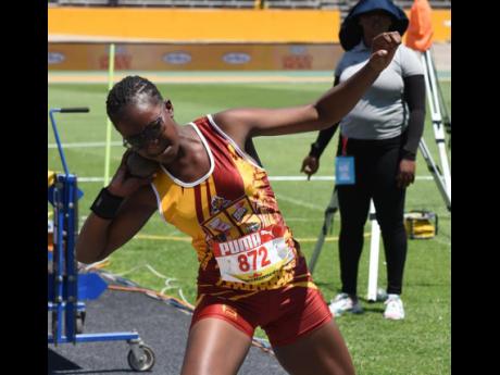 Port Antonio’s Xavier Jones gets ready to throw during the Class 2 Girls’ shot put on yesterday’s opening day at the ISSA/GraceKennedy Boys and Girls’ Athletics Championships at the National Stadium.